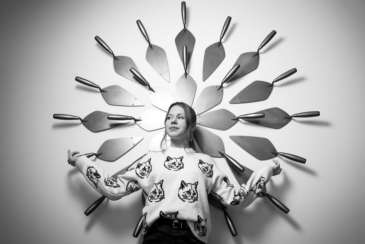 Creative black and white photography with utensils arranged in a sunburst pattern.