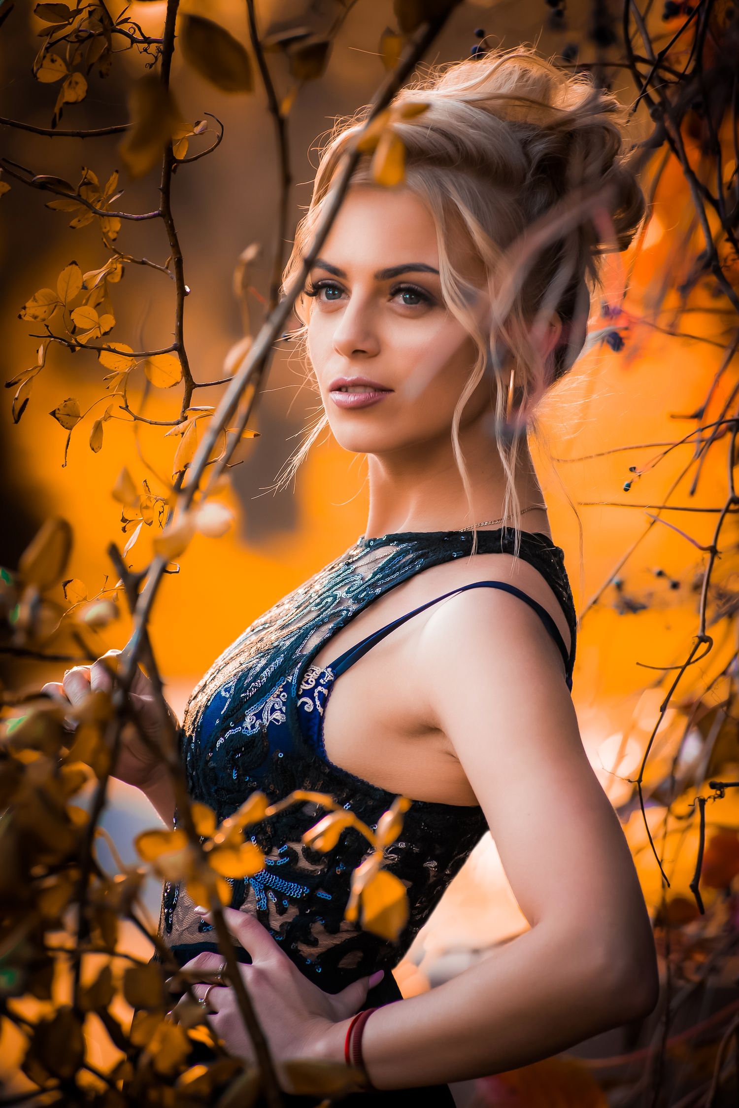 Romantic portrait against orange autumn backdrop with dark lace details.