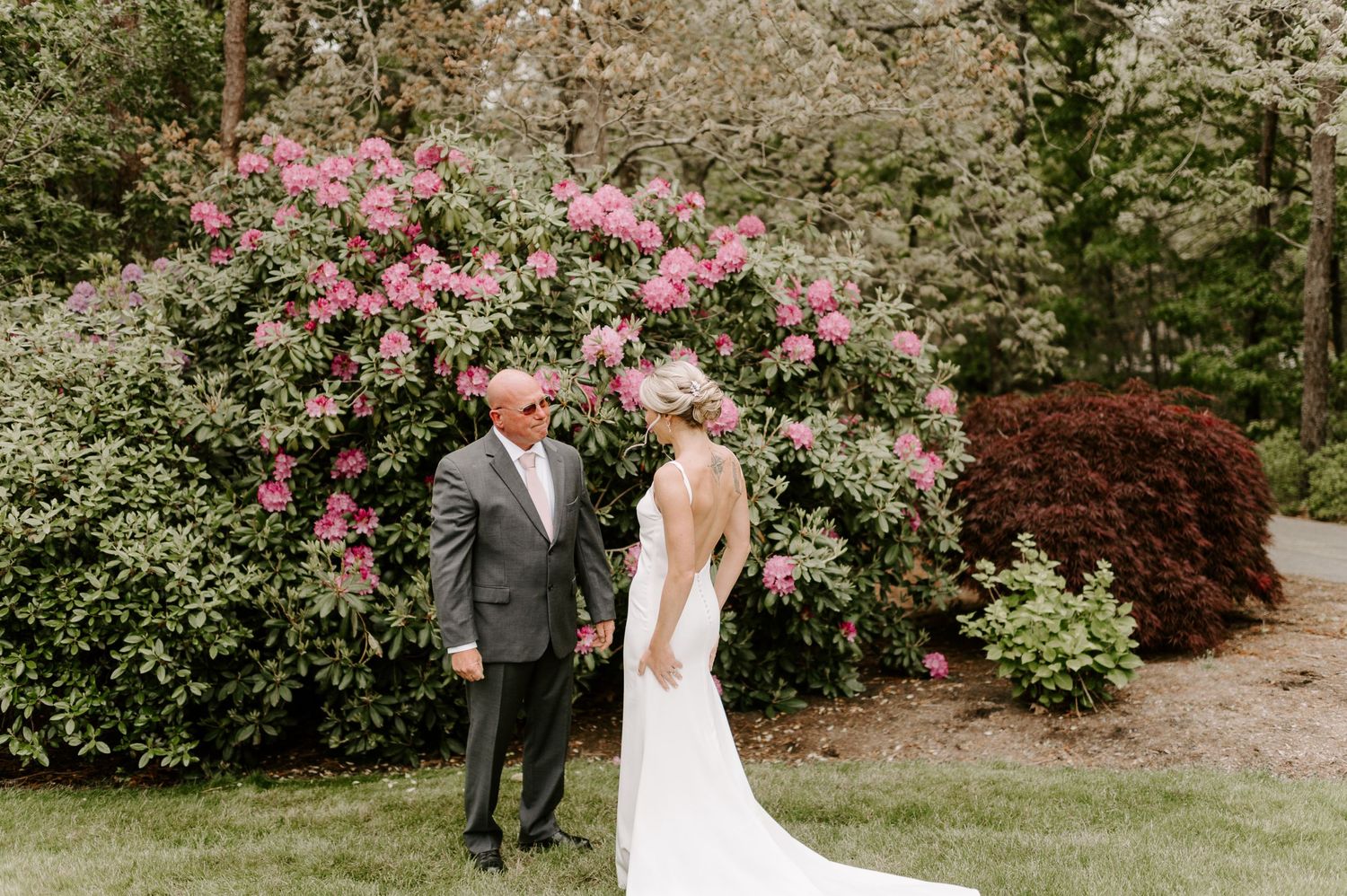 A romantic garden moment with pink flowering bushes creating a beautiful natural backdrop.