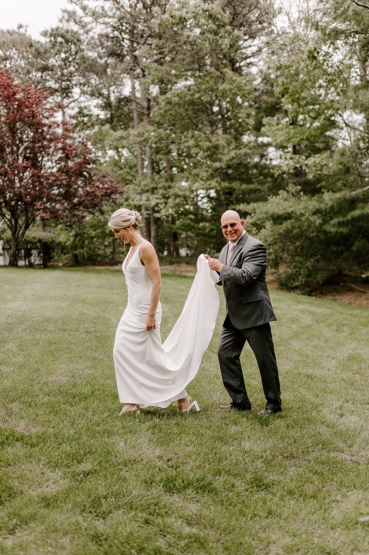 A playful sequence of dance moves on a grassy lawn during a special occasion.