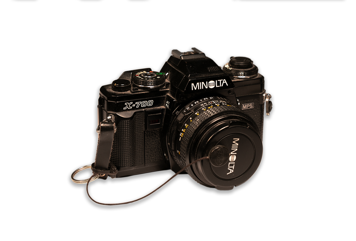 Vintage Minolta film camera with standard lens on dark background.