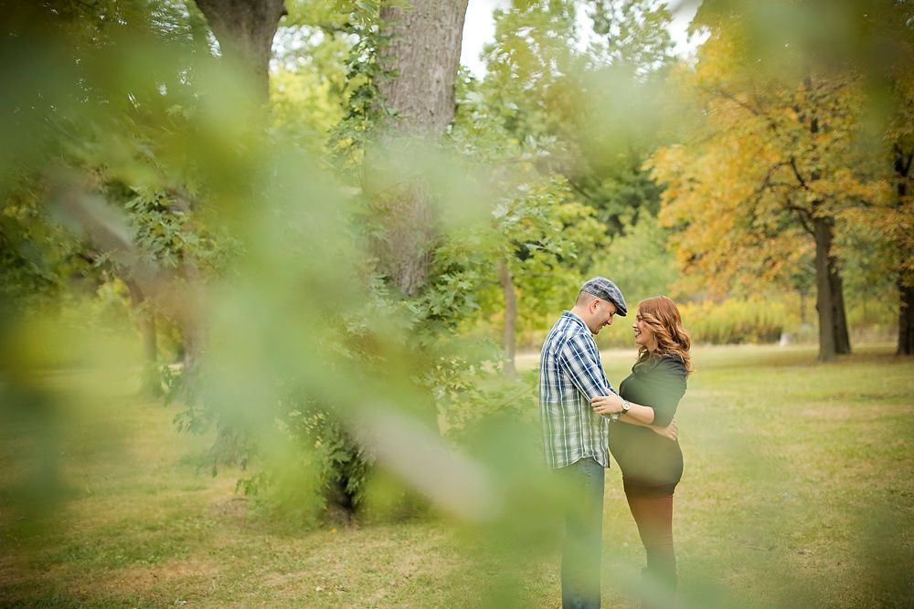 Autumn family photoshoot in park with golden bokeh effect.