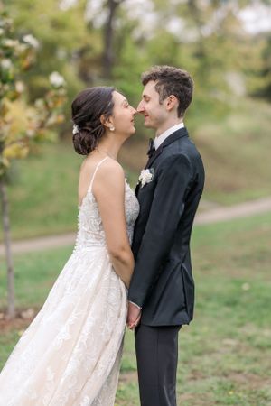 A romantic wedding moment captured in a beautiful outdoor autumn setting.