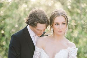 A romantic outdoor wedding portrait in soft, dreamy lighting.