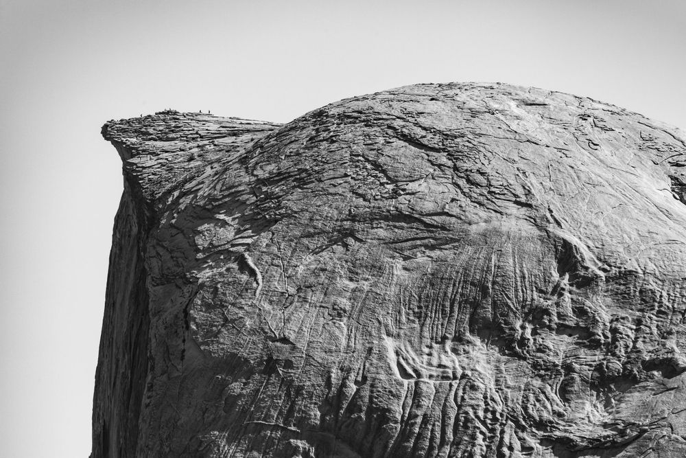 Monochromatic view of a curved granite dome formation with natural erosion patterns.