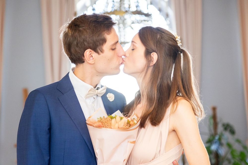 Romantic moment between newlyweds in an elegant indoor setting.