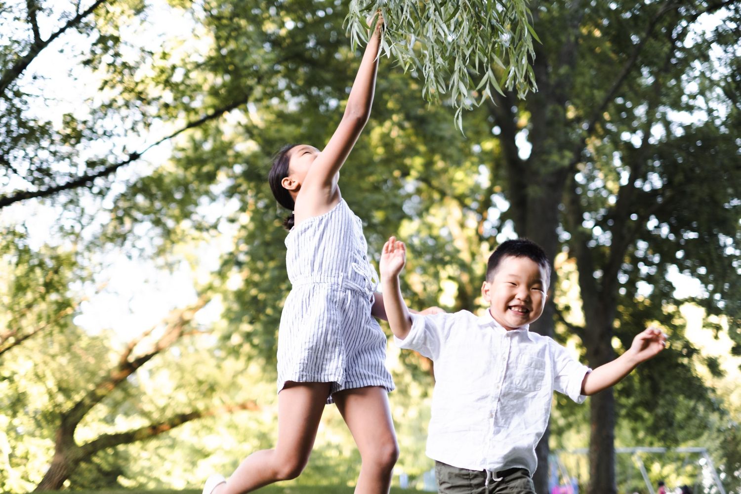 Candid photo of young siblings playfully outdoor