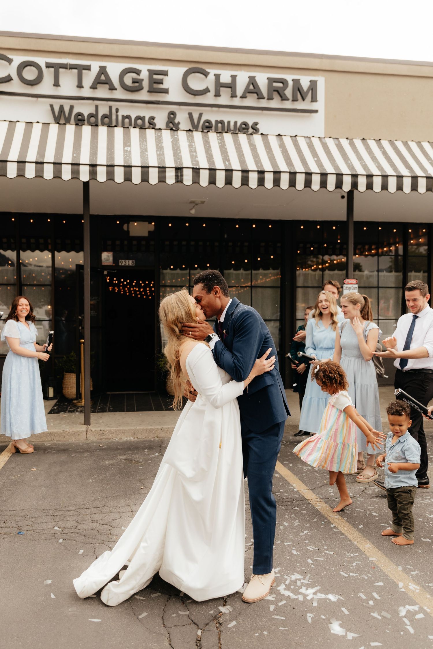 Bride and groom kissing during wedding exit