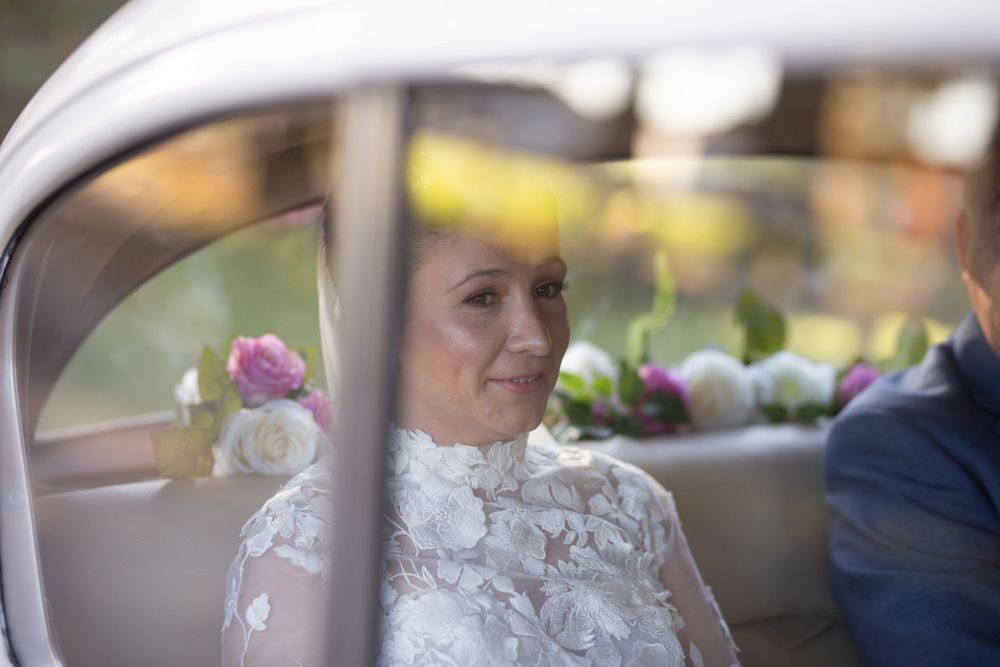 Close-up details of an ornate lace wedding dress in natural lighting.