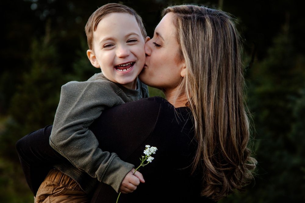 Intimate family moment captured against a dark background.
