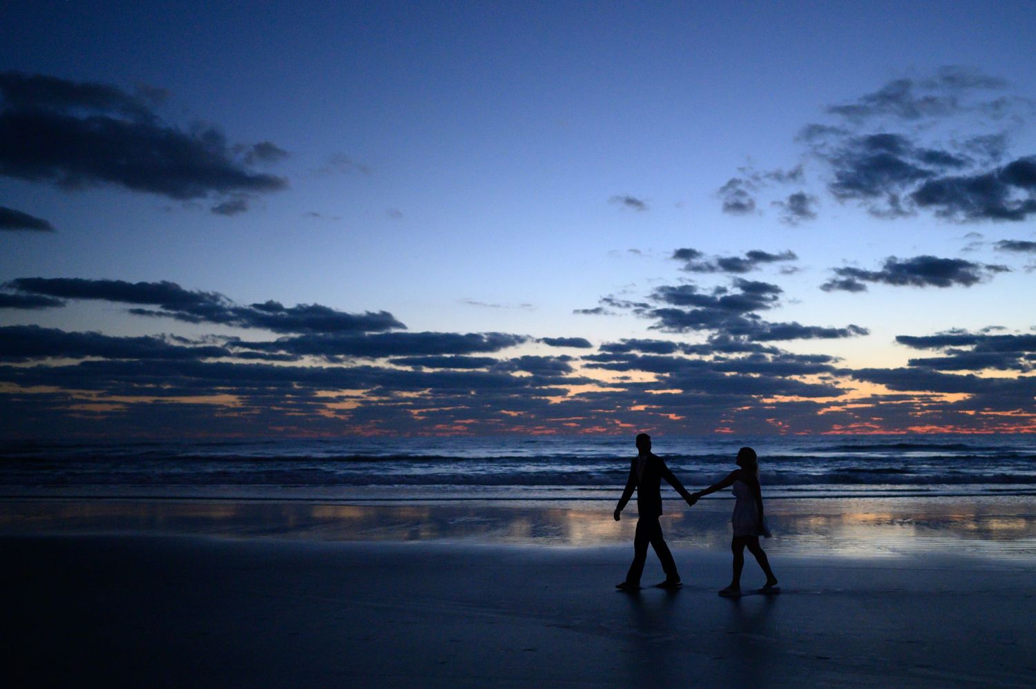 Bride and Groom walking silhouette.