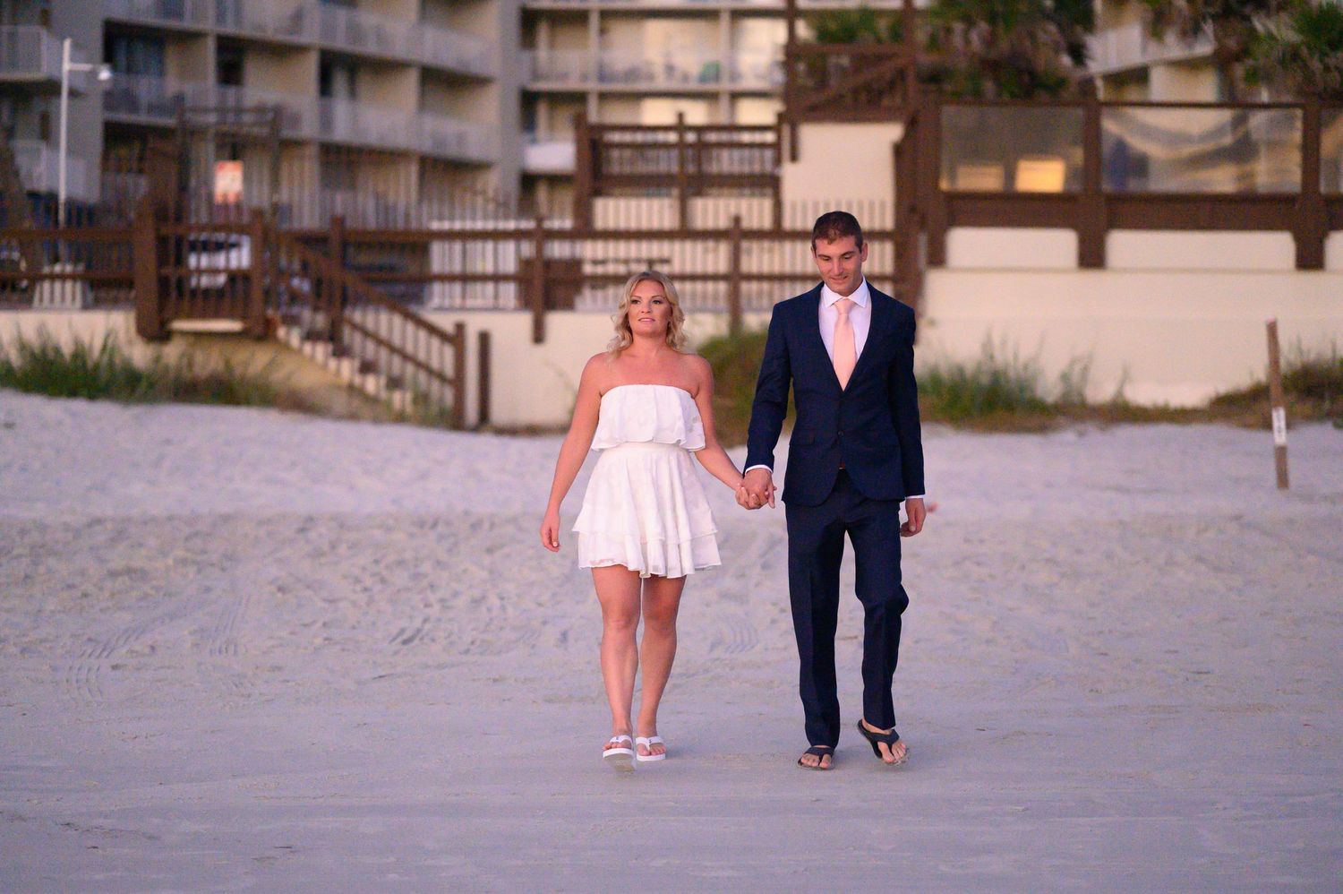 Bride and Groom walking towards the water.