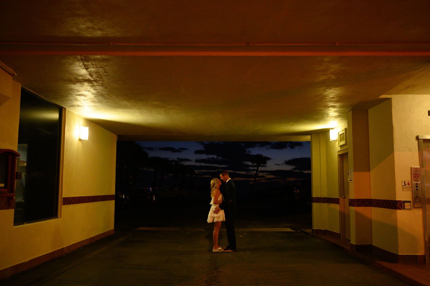 Bride and Groom standing under awning.