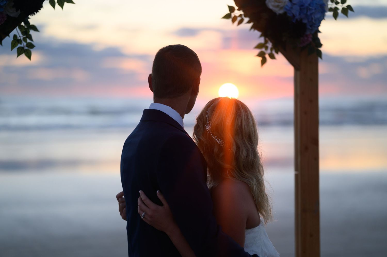 Bride and Groom stare at the rising sun.
