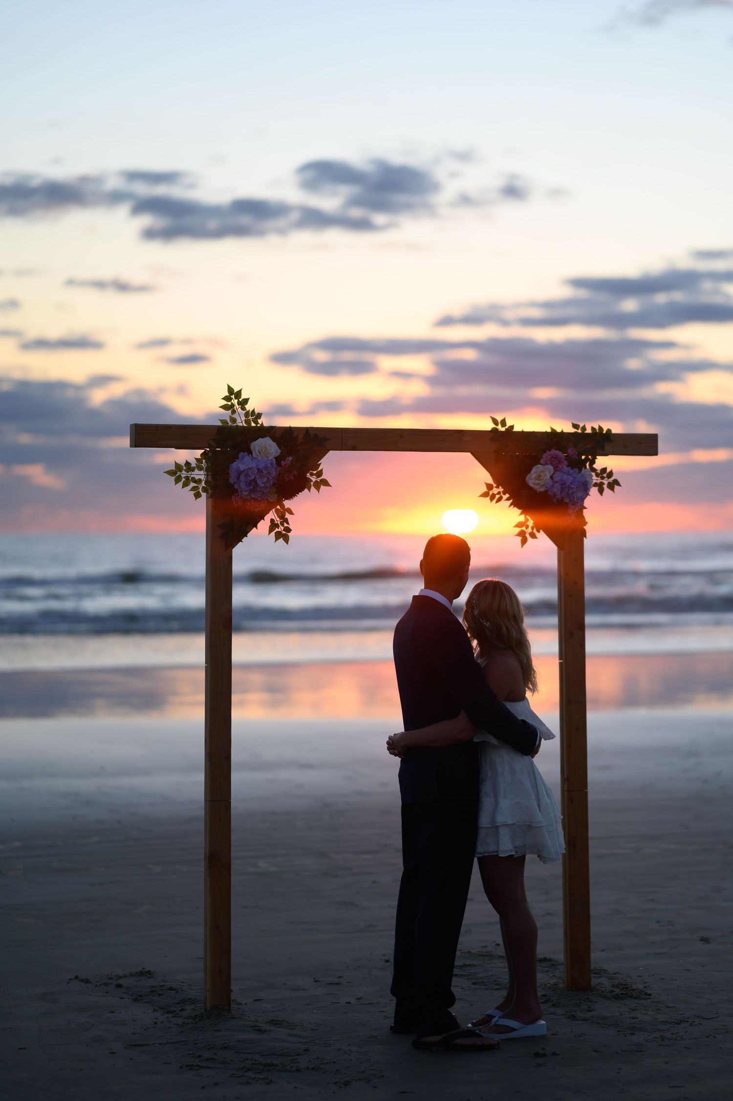 Bride and Groom stare at the rising sun.