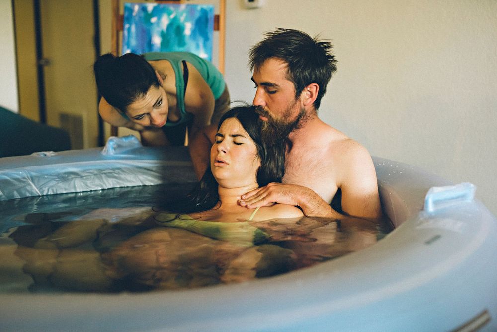 People relaxing together in a hot tub with blue water during an intimate moment.