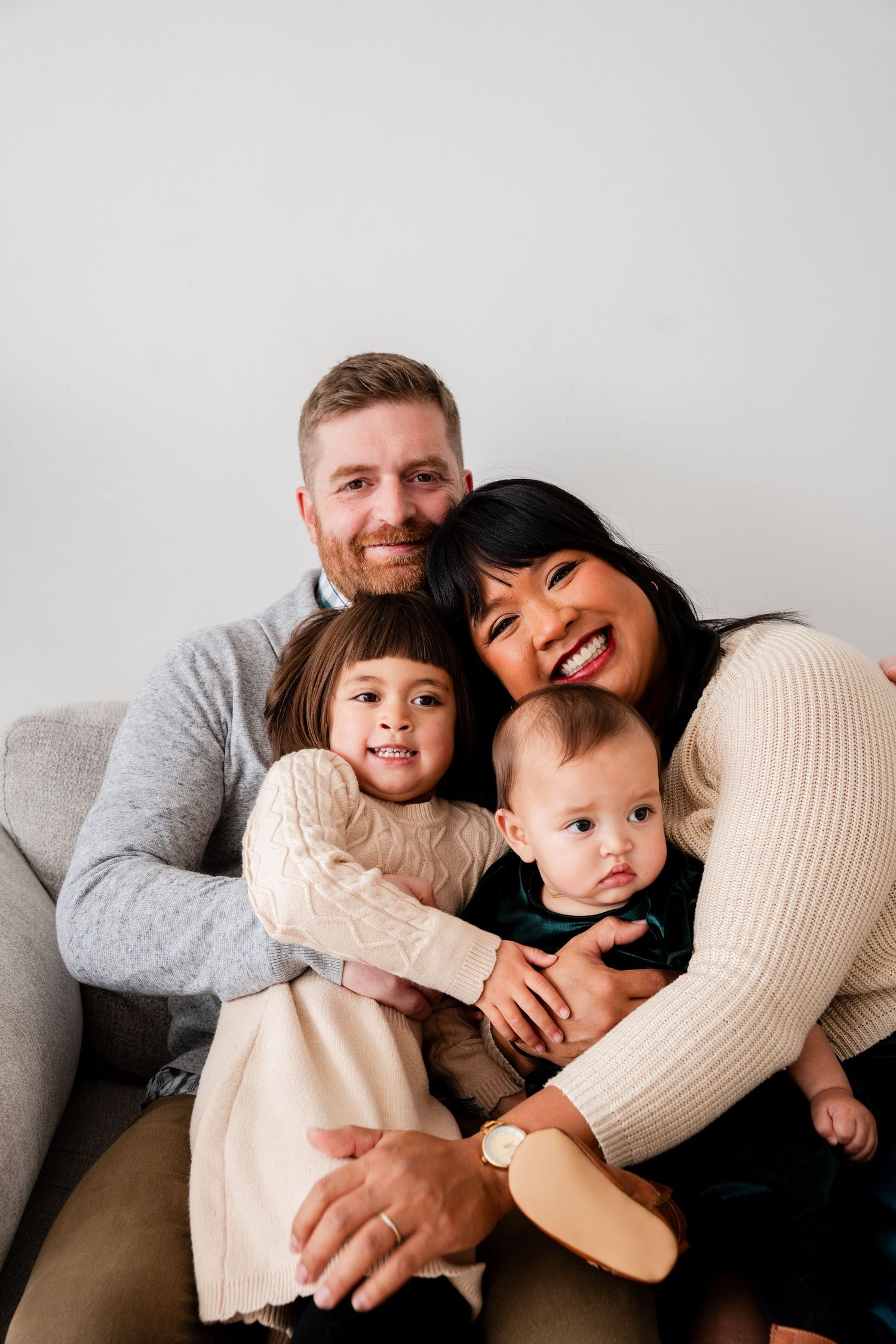 Family holiday portrait beneath a Center Street sign and decorated Christmas tree.