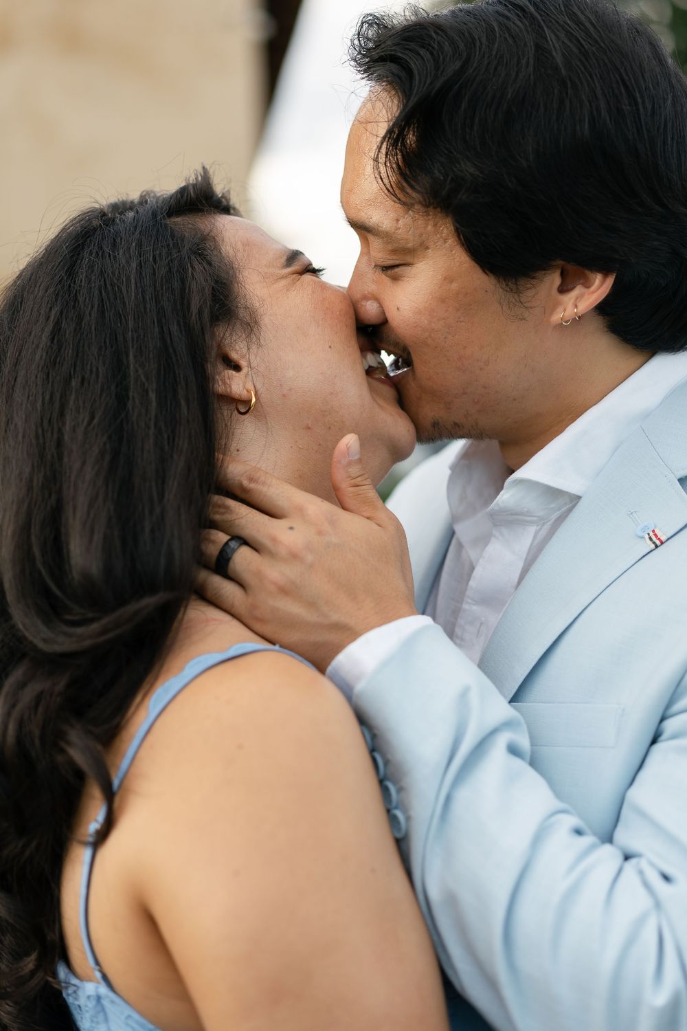 A couple share a series of romantic kisses while standing close together, showing their affection in connected photos.