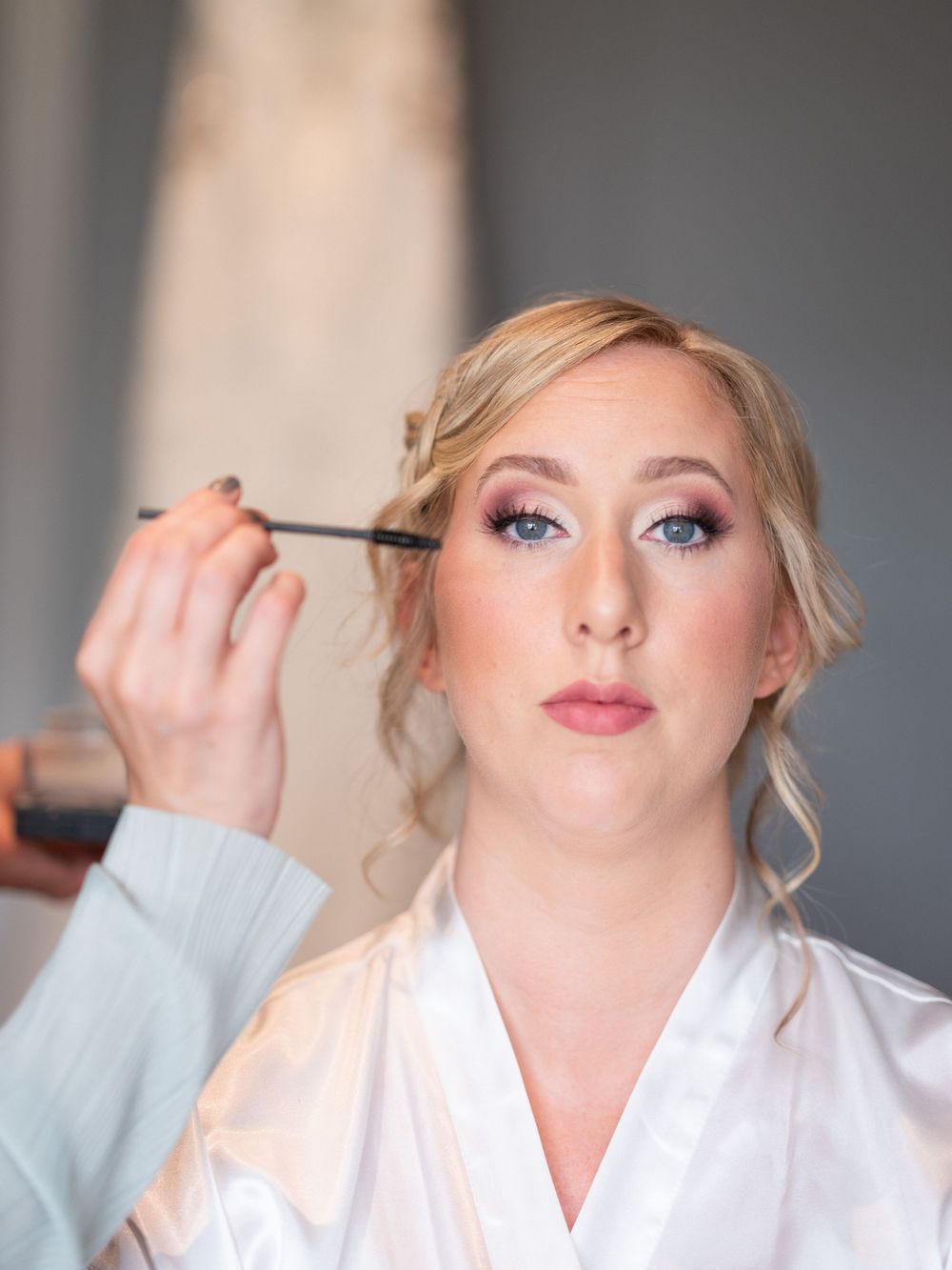 Beautiful bride having the last touches of make up done.