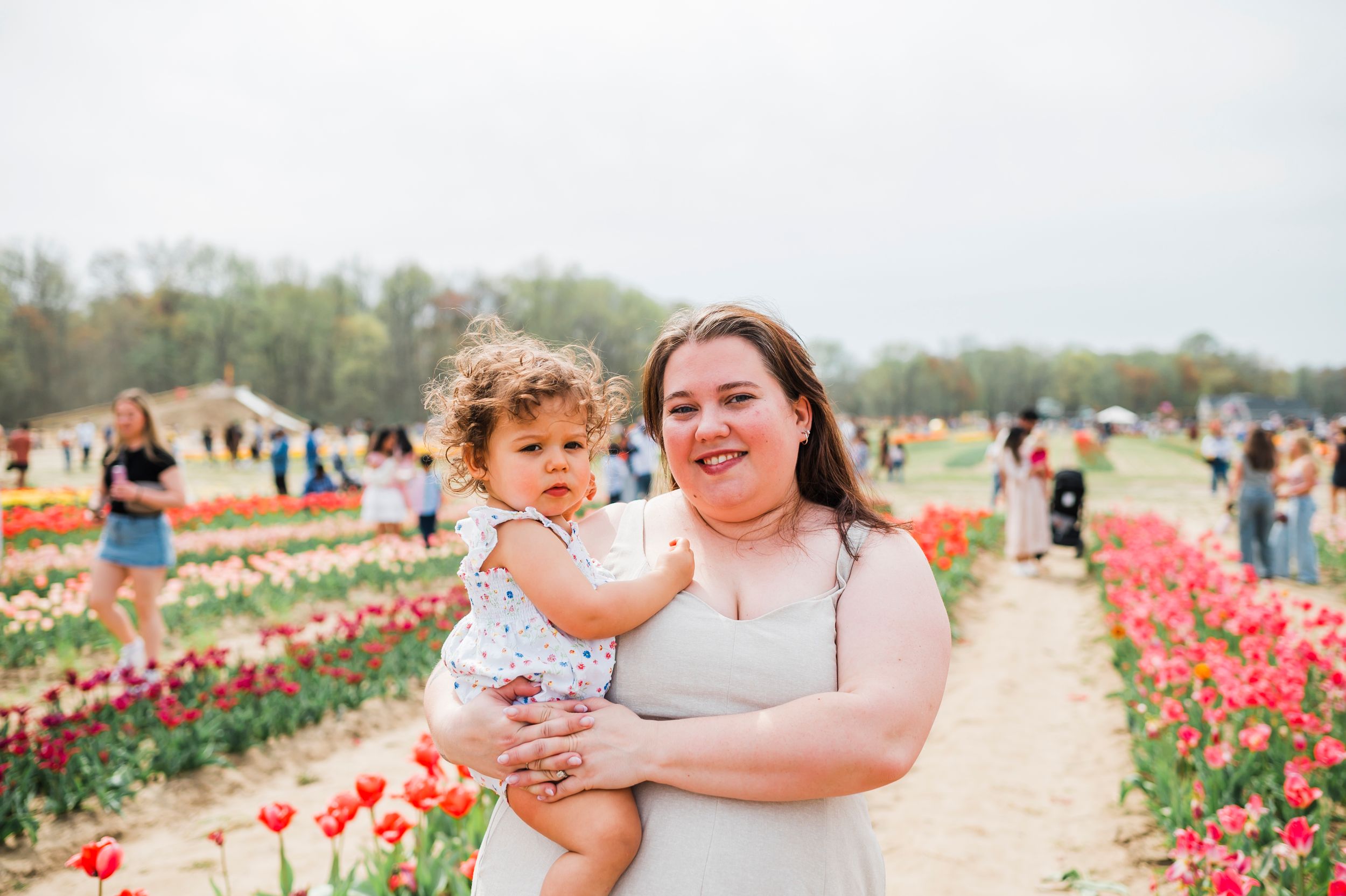 A joyful moment shared among visitors at a tulip garden during peak bloom season.