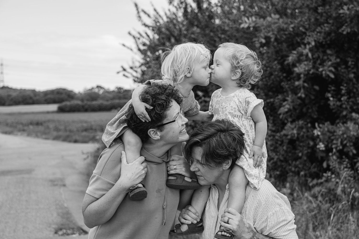 Heartwarming group embrace captured in black and white on country path.
