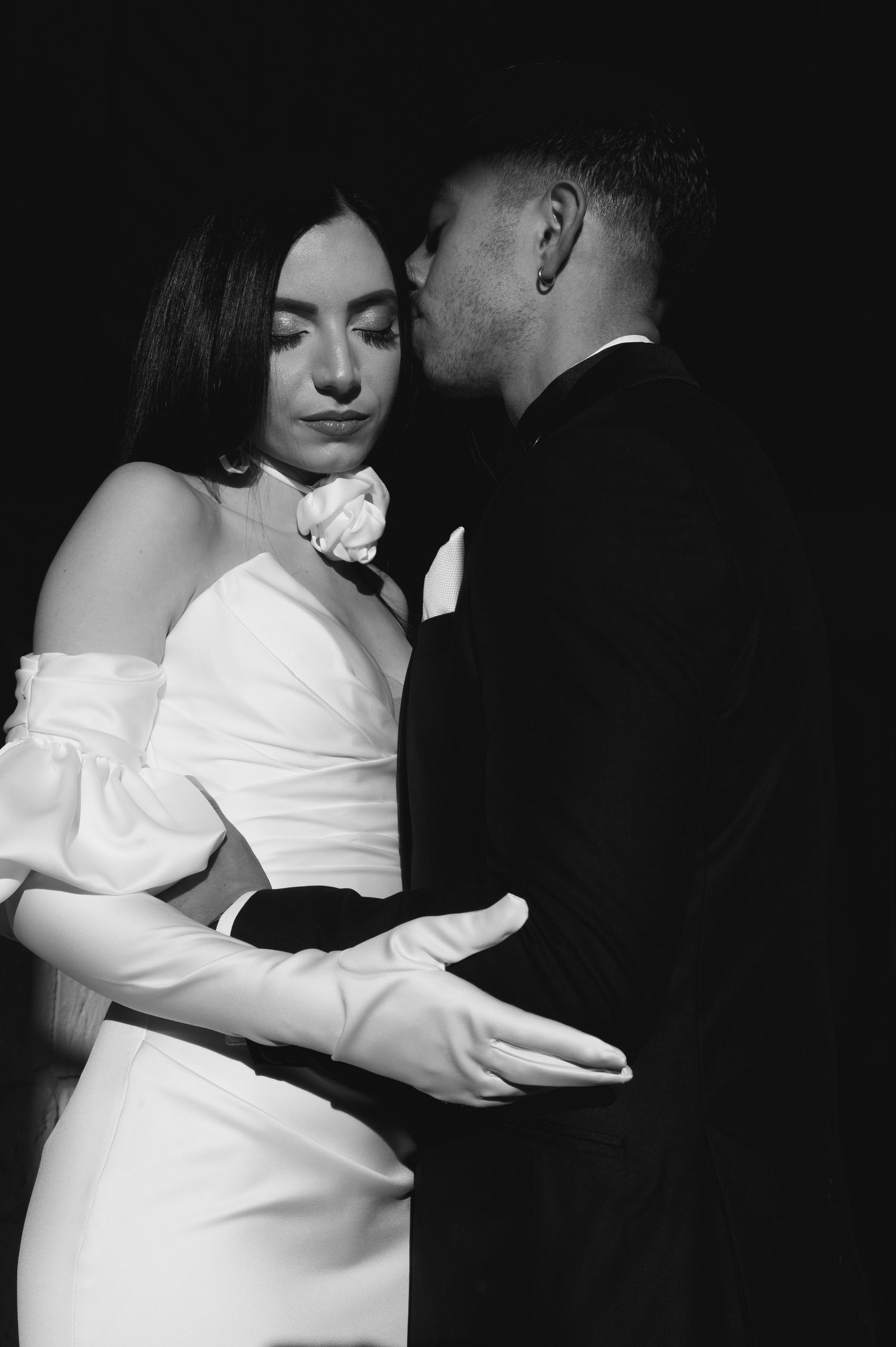 A series of black and white wedding photos showing intimate moments between a couple during their celebration.