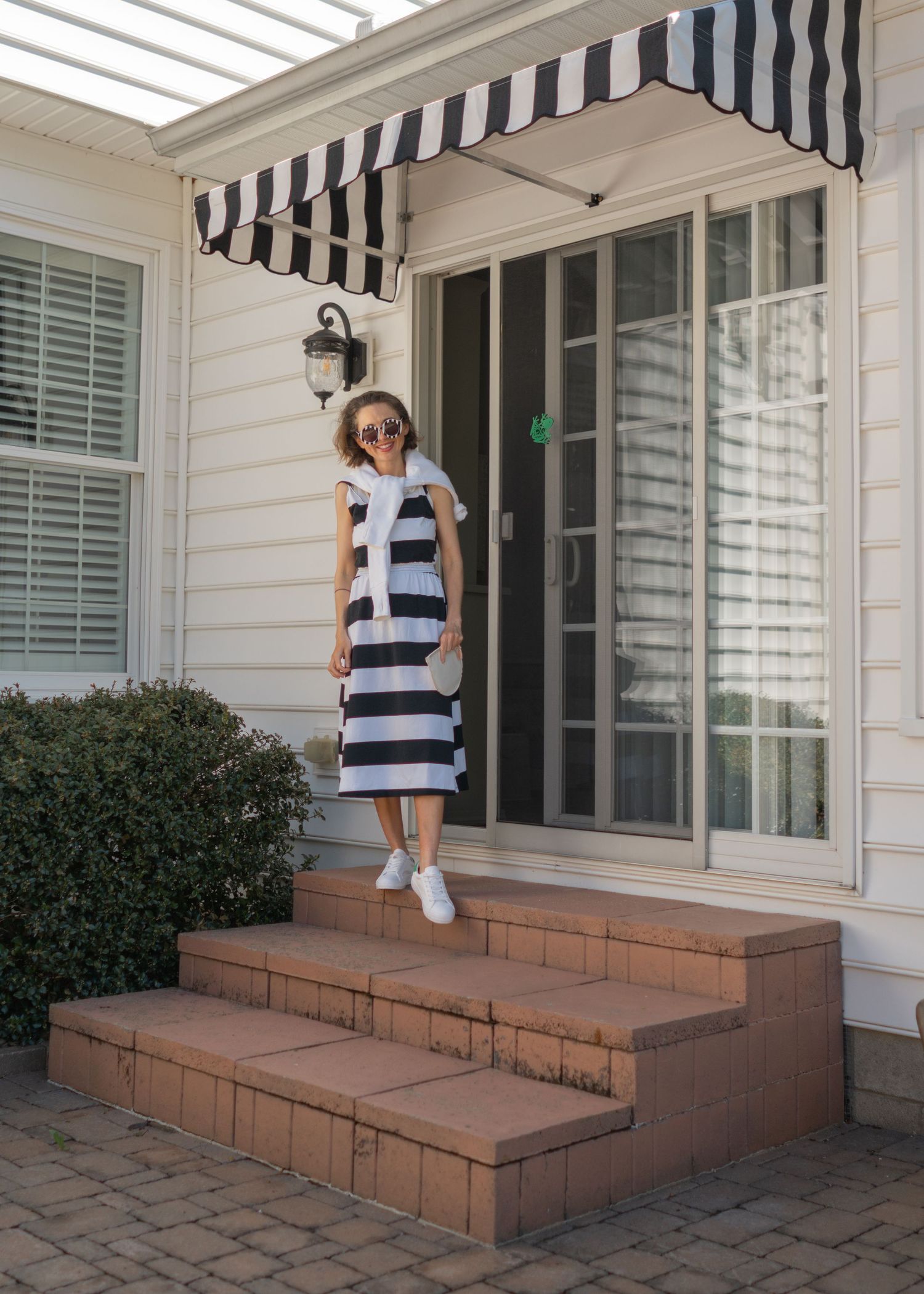 woman wearing black and white dress standing on the stairs