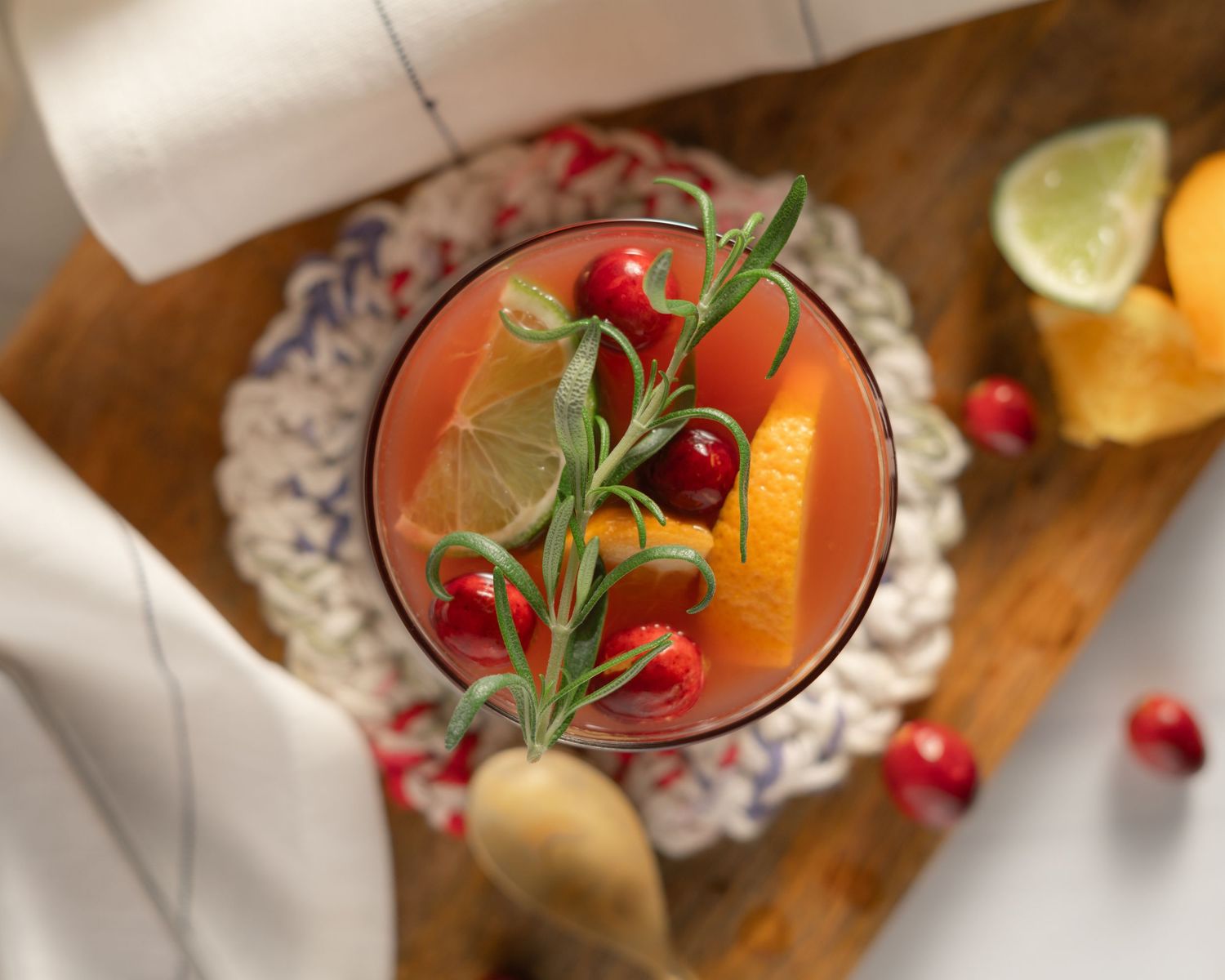 flat lay of cranberry cocktail garnished with rosemary