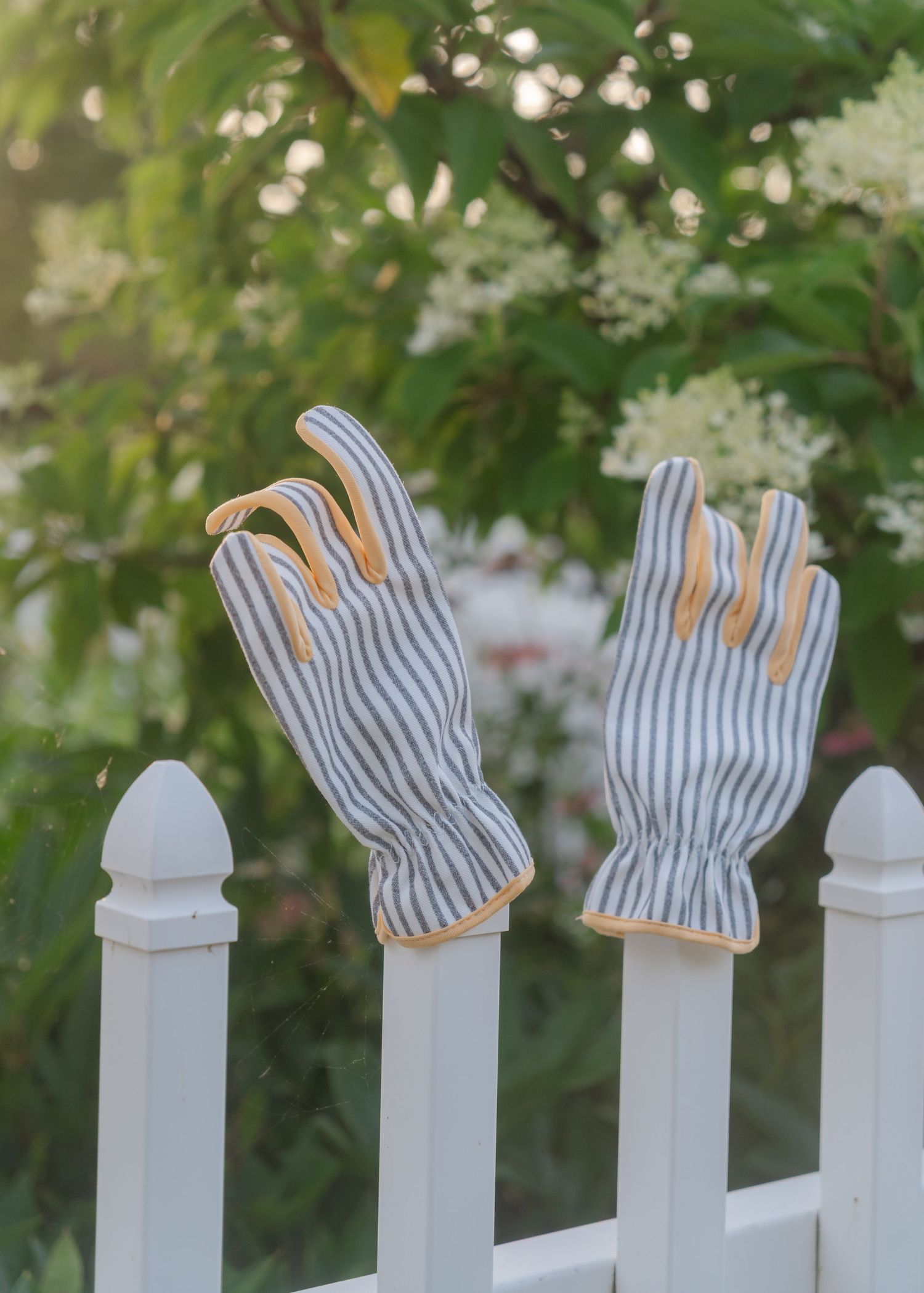 stripe garden gloves on fence post