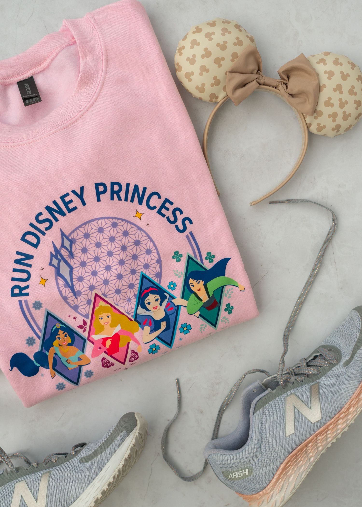 Flay Lay of pink Run Disney Princess Sweatshirt with gray running shoes