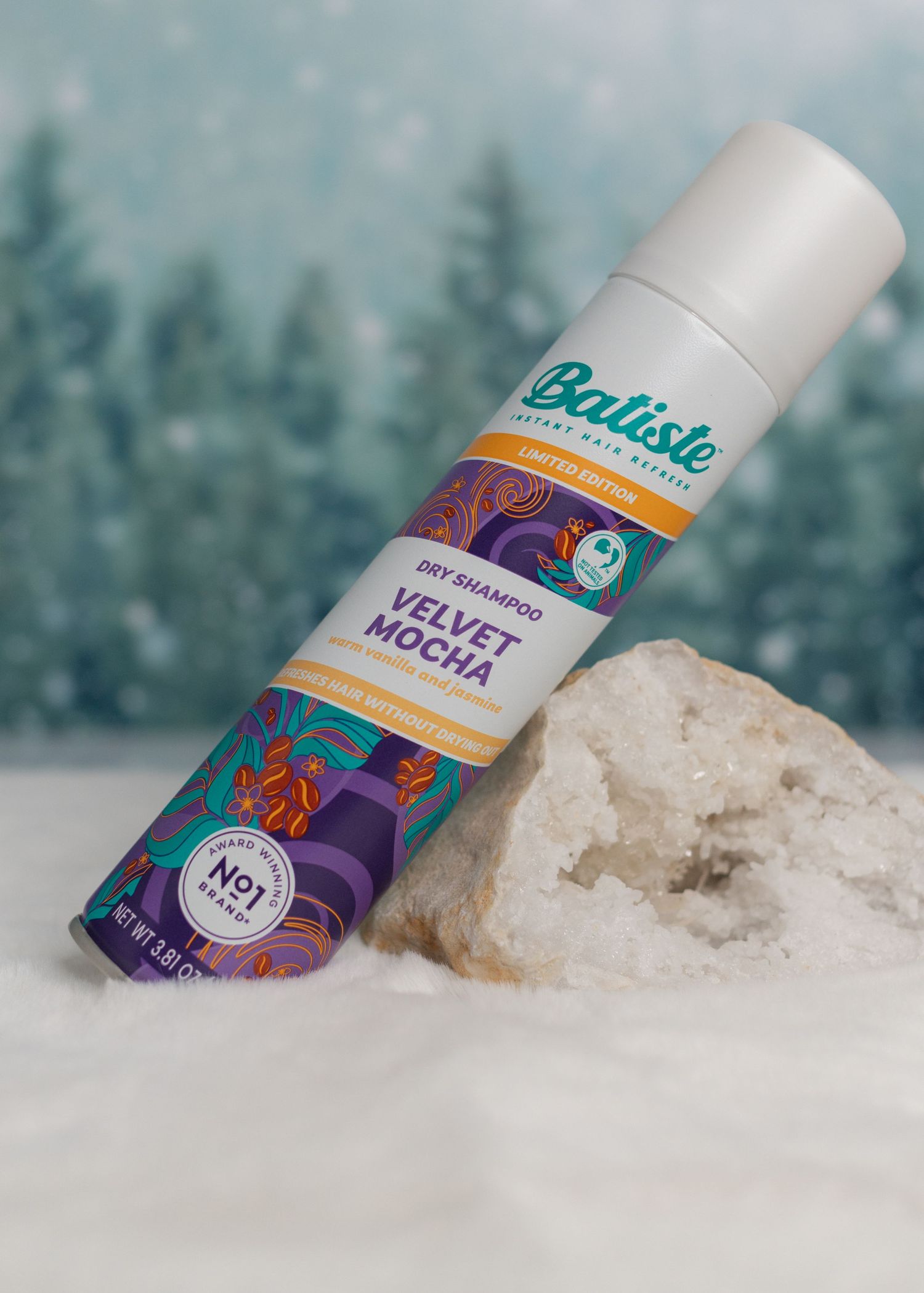 Bottle of Batiste Velvet Mocha Dry Shampoo leaning on sparkly gem