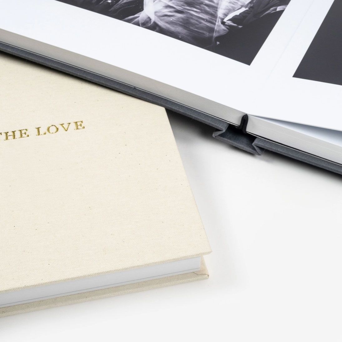 Wedding album with gold lettering reading 'THE LOVE' alongside photo prints.