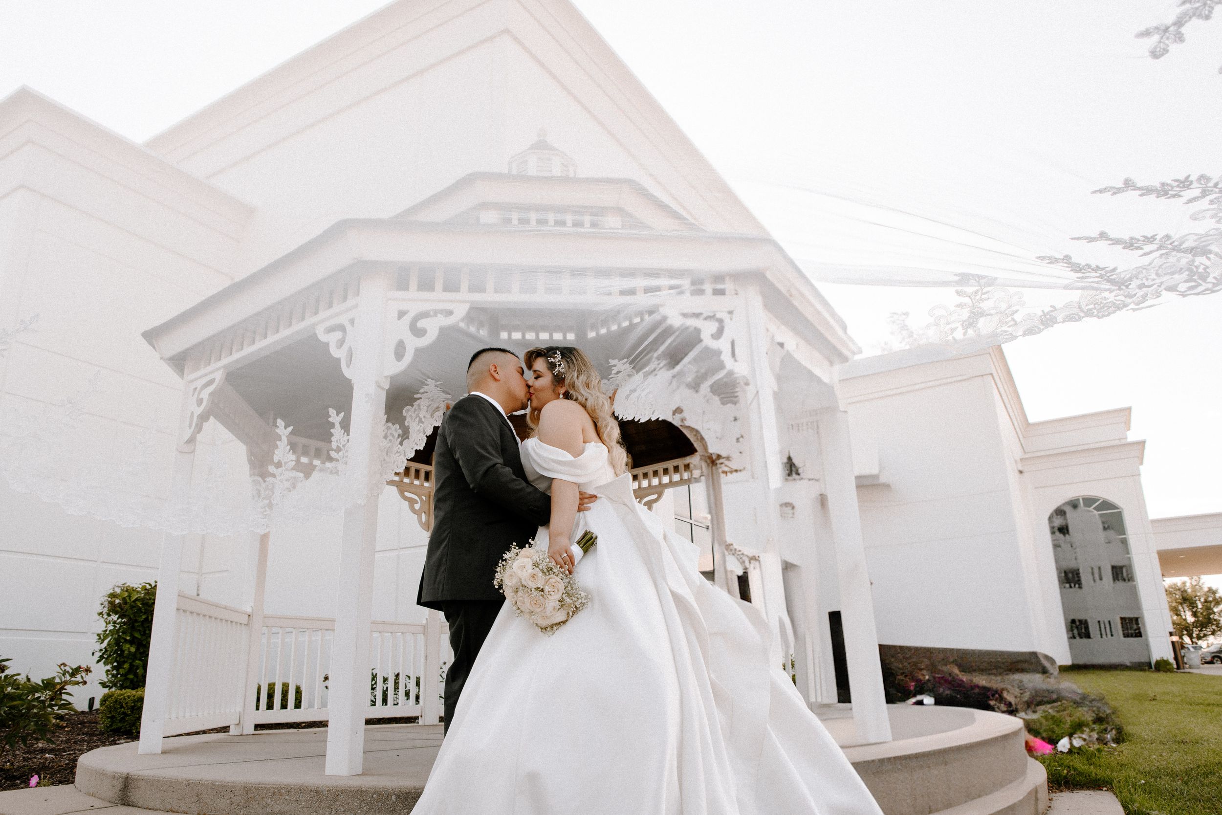 Elegant collage of wedding photos featuring a white colonial style venue with sweeping coastal scenery and romantic moments.