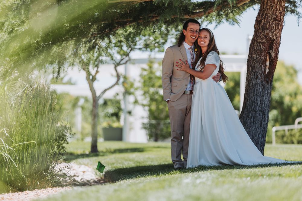 A series of romantic wedding photos taken outdoors featuring a couple in formal attire under tall pine trees.