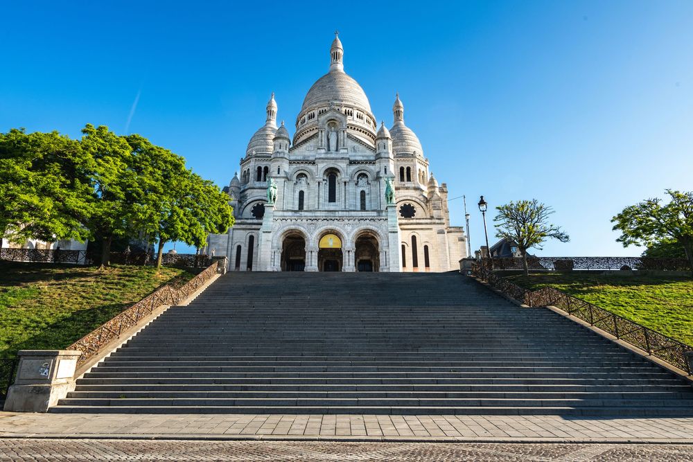 Panoramic view of the iconic white domed Sacre Coeur Basilica at different angles on Montmartre hill in Paris, France.