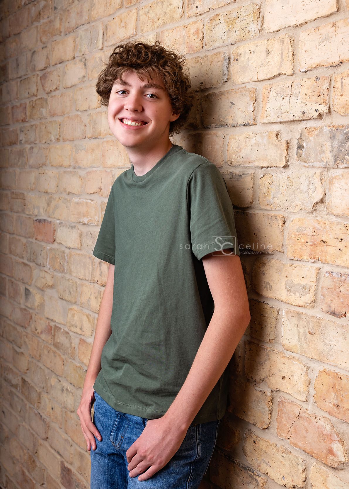 A casual portrait series against a brick wall showing someone in a green t-shirt and blue jeans in various natural poses.