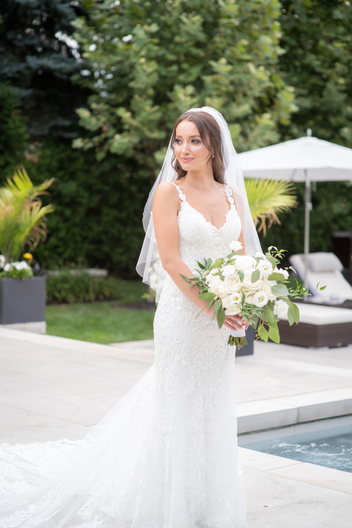 Bride holding flowers in a white dress.