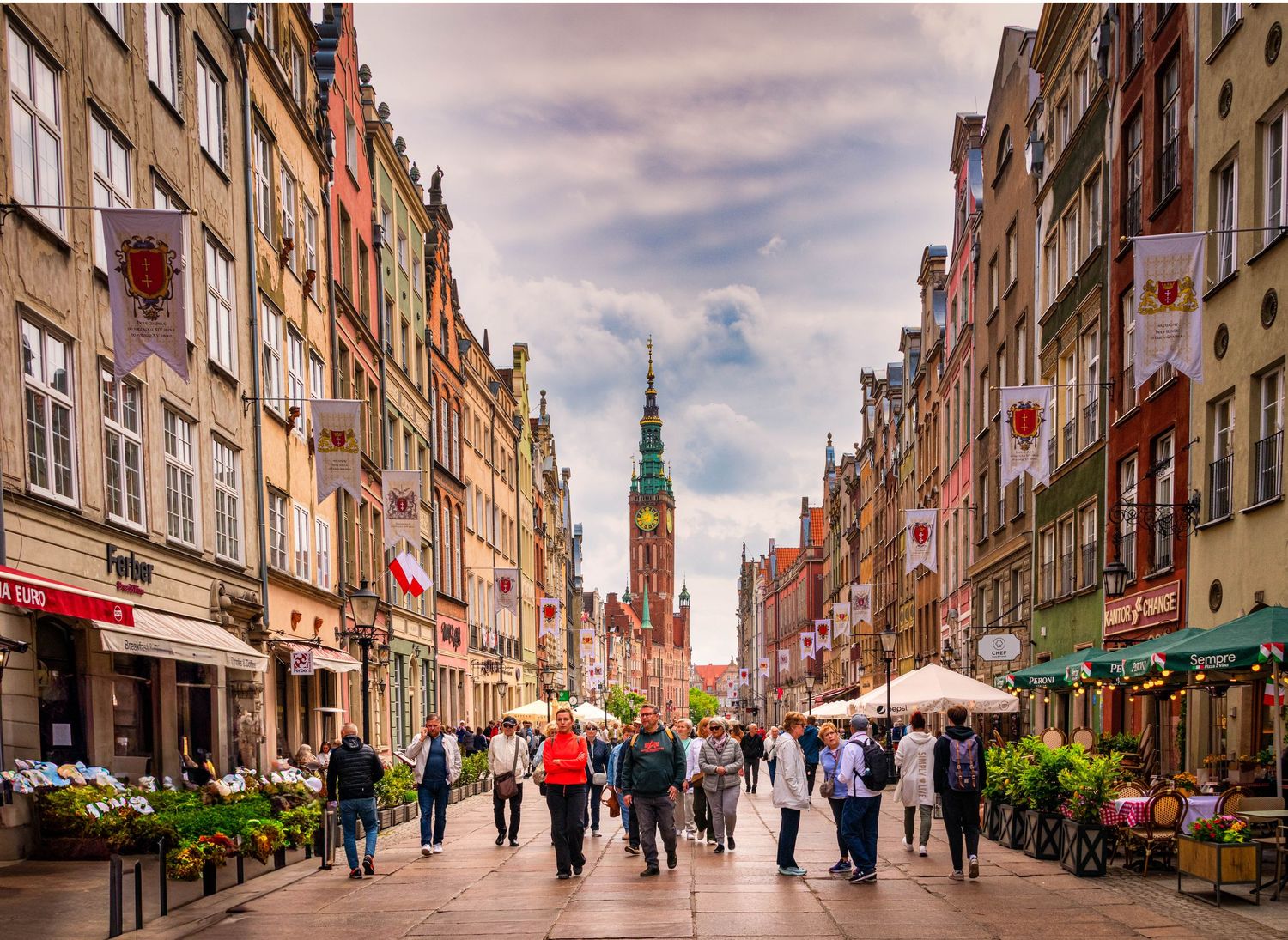 Historic Long Market street in Gdansk with traditional architecture and pedestrians walking along cobblestones.