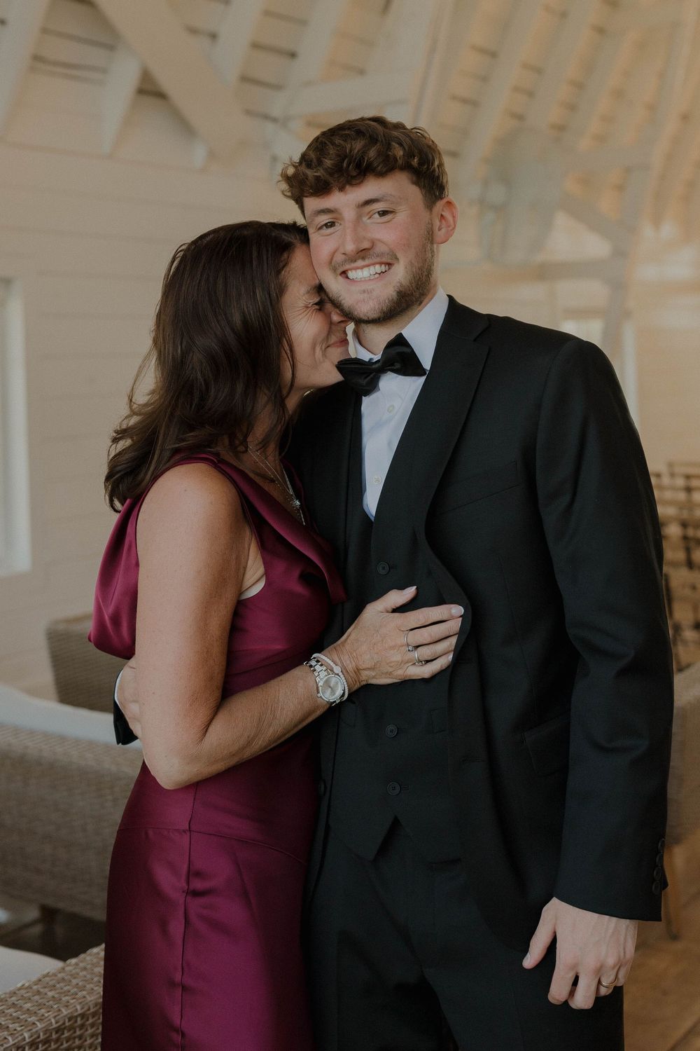 A couple shares intimate moments in a series of candid shots showing them laughing and embracing.
