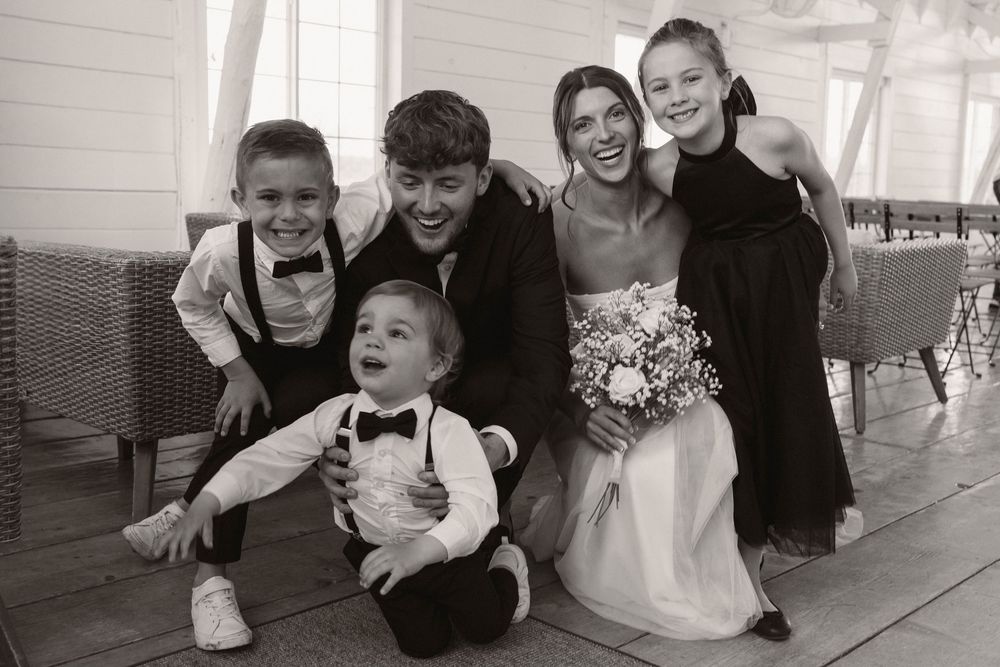 Candid black and white photos capture joyful moments between wedding party members.