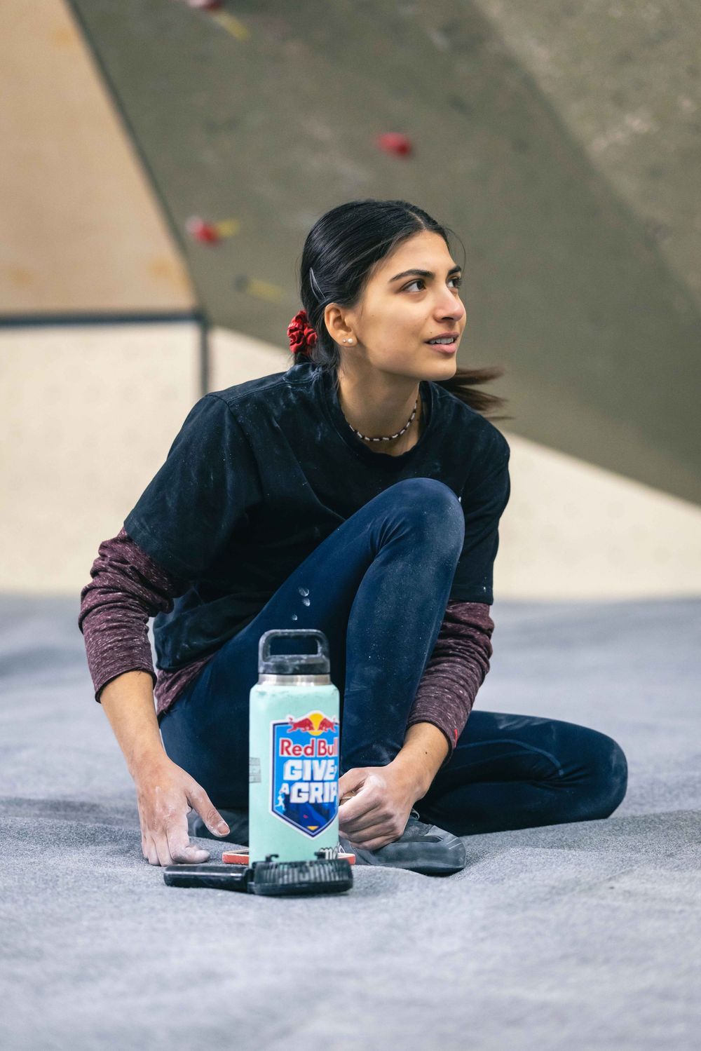 American professional rock climber Natalia Grossman trains on an indoor climbing wall in Paris, France, wearing athletic gear.
