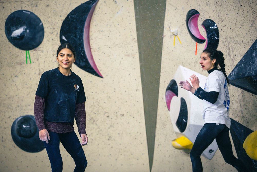 American professional rock climber Natalia Grossman trains on an indoor climbing wall in Paris, France, wearing athletic gear.