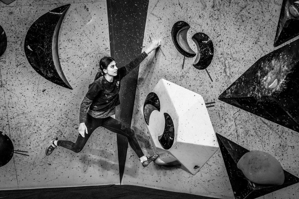 American professional rock climber Natalia Grossman trains on an indoor climbing wall in Paris, France, wearing athletic gear.