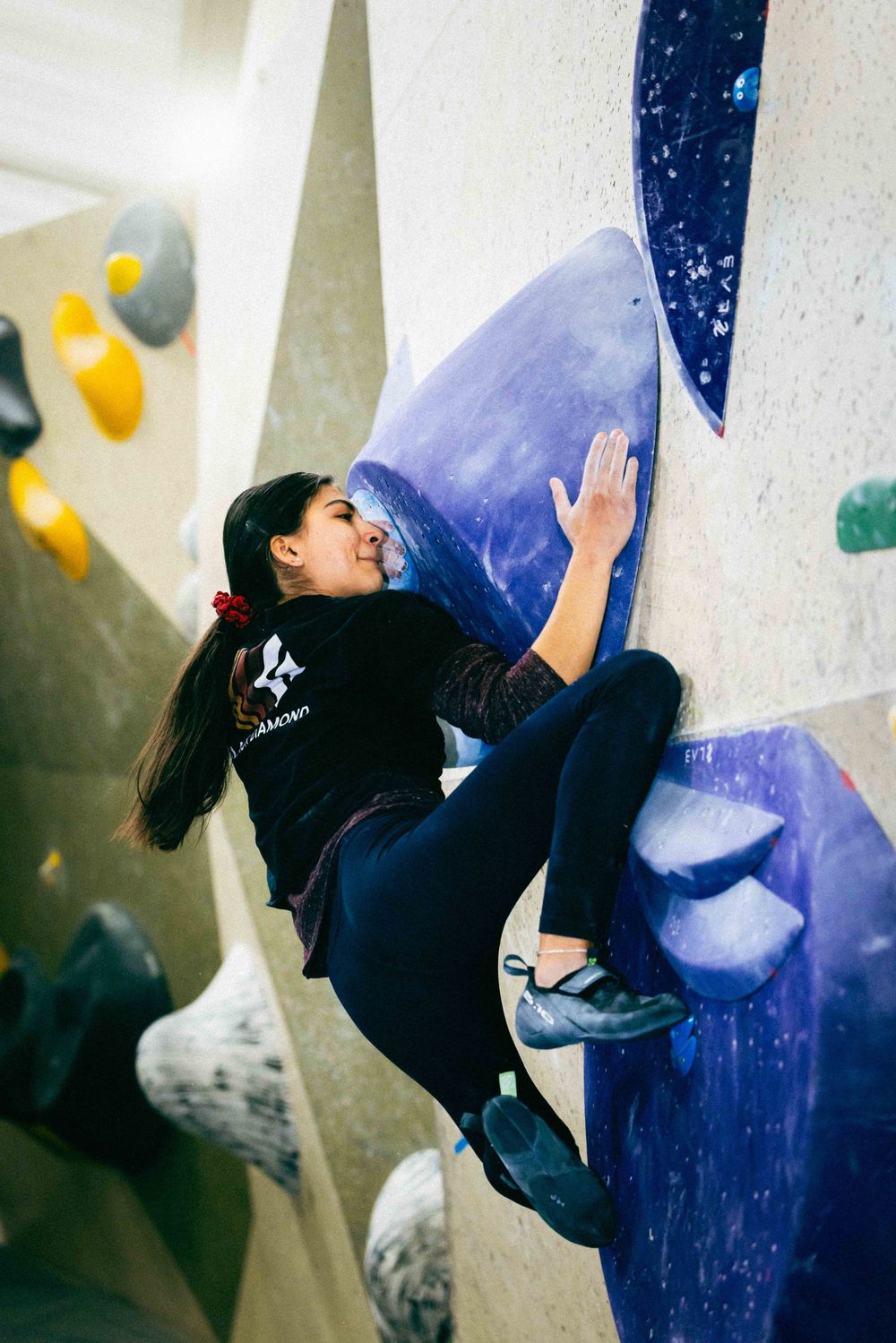 American professional rock climber Natalia Grossman trains on an indoor climbing wall in Paris, France, wearing athletic gear.