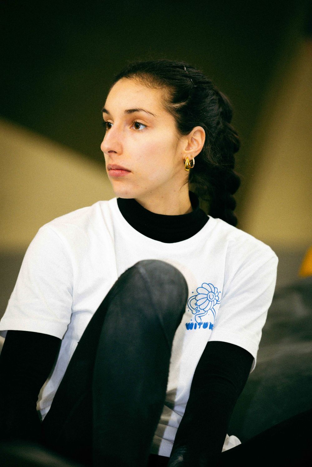 French professional rock climber SELMA ELHADJ MIMOUNE trains on an indoor climbing wall in Paris, France, wearing athletic gear.