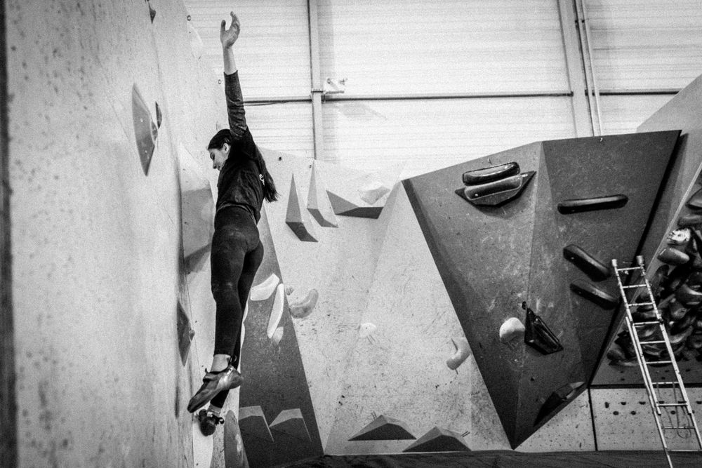 American professional rock climber Natalia Grossman trains on an indoor climbing wall in Paris, France, wearing athletic gear.