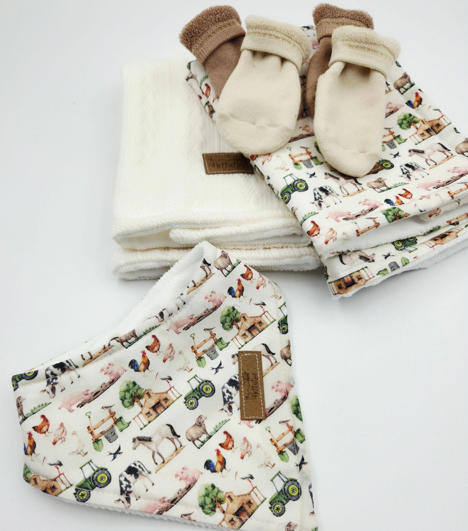 Baby blanket with vintage tractor print and matching accessories.