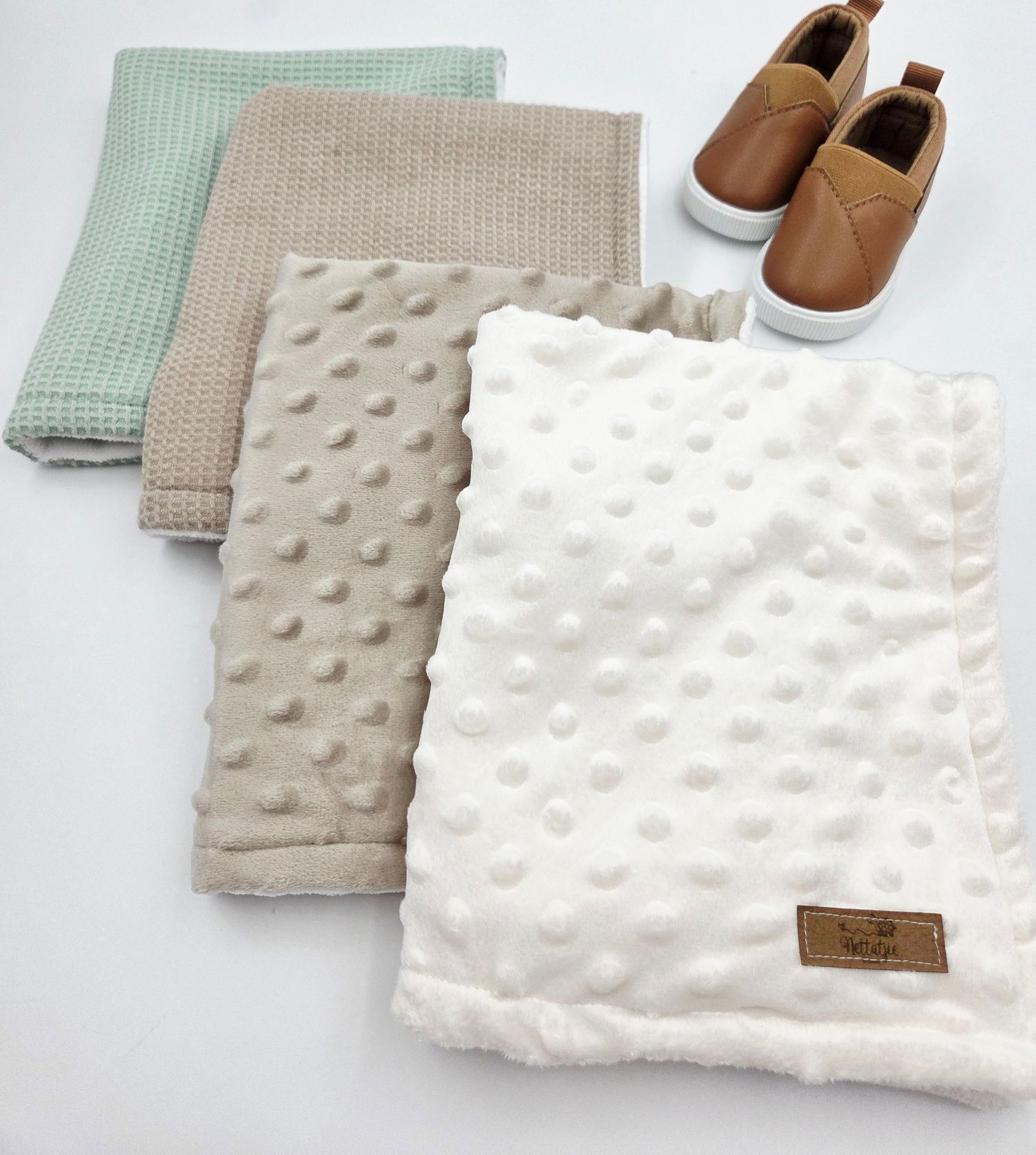 Soft minky dot blanket set in mint and neutral tones with leather shoes.