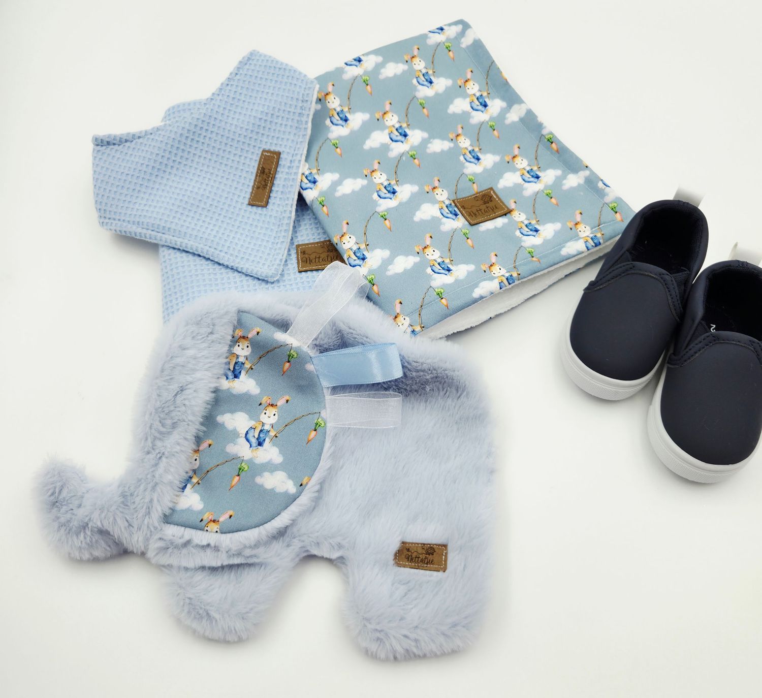 Light blue baby set with animal print pattern and navy shoes displayed on white background.