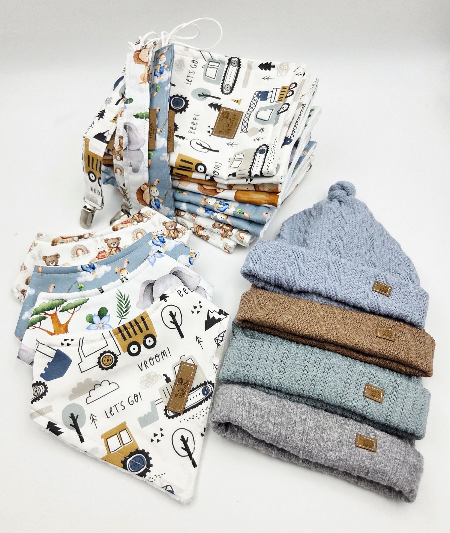 Cozy knit baby beanies and coordinating animal print fabric accessories laid flat.